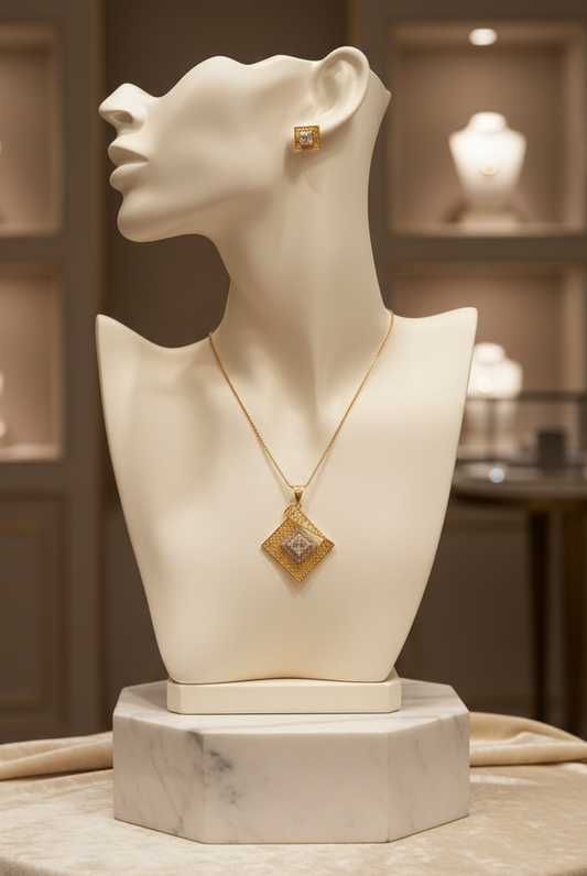 Gold pendant and stud earring set on mannequin