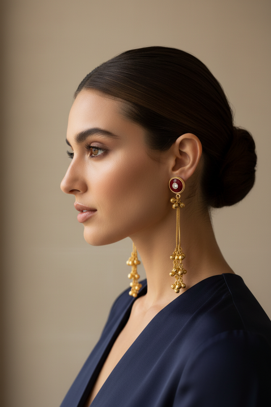 Model wearing red enamel tassel earrings
